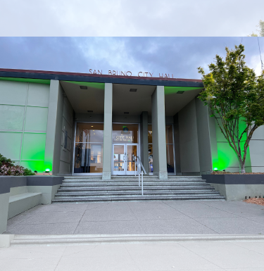 Image of City Hall lit up in green